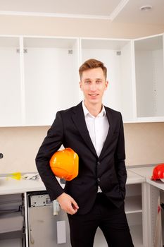 engineer in the new interior, with protective helmet under his arm