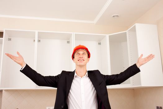 proud smiling foreman shows the quality of repairs in a new apartment