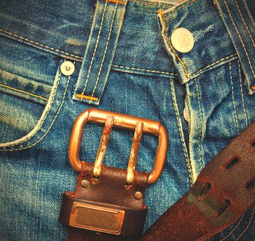 part of a vintage jeans with old leather belt 