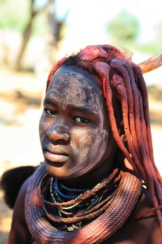 EPUPA, NAMIBIA - MAY 2011: An unidentified Himba woman poses for photographers at a Himba village on May 27th, 2011. Entrance fee to the village is a specified food parcel