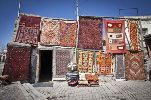 Colorful Turkish rugs being sold in a market