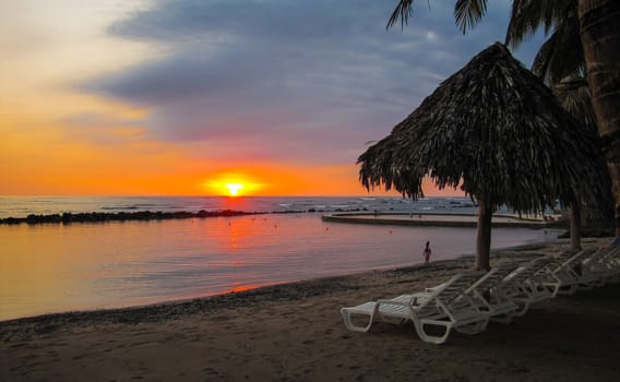 Sun goes down on a beach and salt water pool at a resort in El Salvador, Central America.