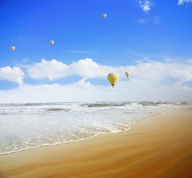 Air balloons flying over the tropical summer beach