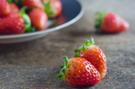 close up fresh red strawberries over wooden background