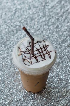 Iced coffee with straw in plastic cup for take aways