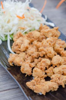 deep fried chicken tendons with fresh vegetable and chili sauce, asian style cuisine