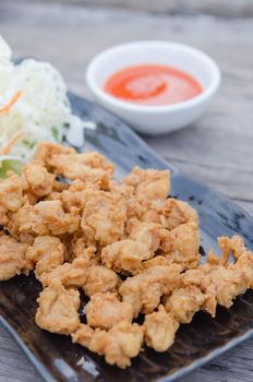 deep fried chicken tendons with fresh vegetable and chili sauce, asian style cuisine