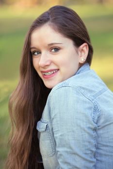 Pretty teenage girl smiling and looking over her shoulder