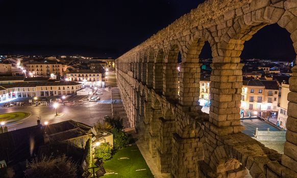 A night time view of the old Roman Aqueduct in the middle of Segovia Spain.