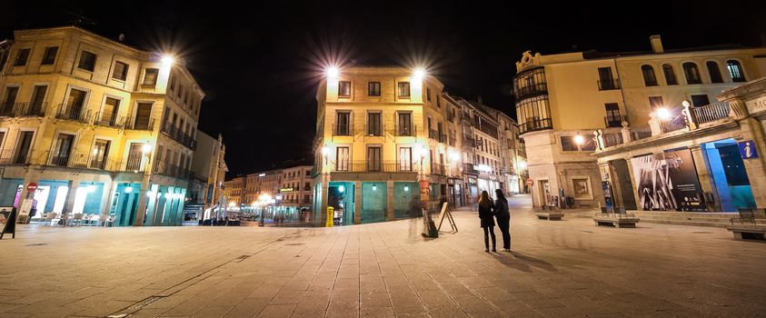 A night time view of the town square in Segovia Spain.