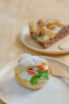 fresh strawberry Choux Cream on wooden dish
