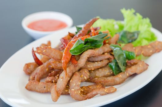 Closeup of fresh fried meat with sesame and chili