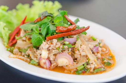 spicy minced pork eaten with fresh vegetable on plate , asian food