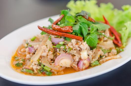 spicy minced pork eaten with fresh vegetable on plate , asian food
