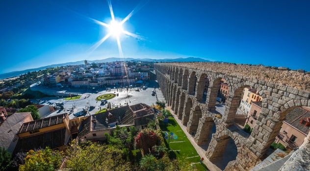 Sun rises on the Segovia Market Square and famous Aqueduct.