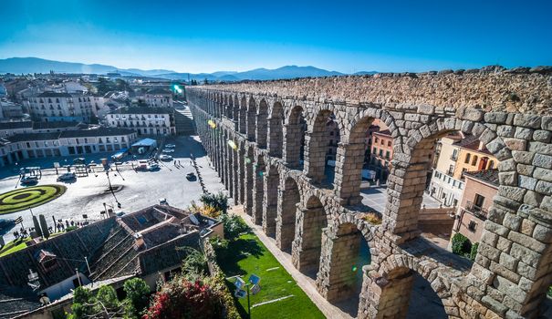 Sun rises on the Segovia Market Square and famous Aqueduct.