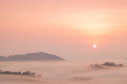 Fog covered mountains And the rising sun. Fog that covered the mountains and forests in the morning.