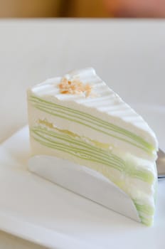 close up of green crepe cake , sweet dessert on dish