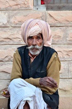 Jodhpur, India - January 2, 2015: Unidentified Indian senior man in the Jodhpur village on January 2, 2015 in Jodhpur, India. Jodhpur is know as the blue city.