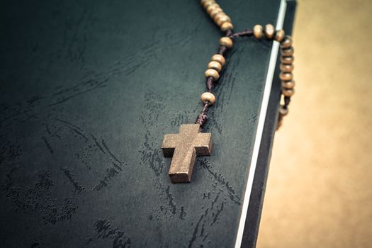 Christian cross necklace on Holy Bible book, Jesus religion concept as good friday or easter festival