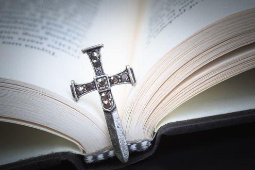 Christian cross necklace on Holy Bible book, Jesus religion concept as good friday or easter festival