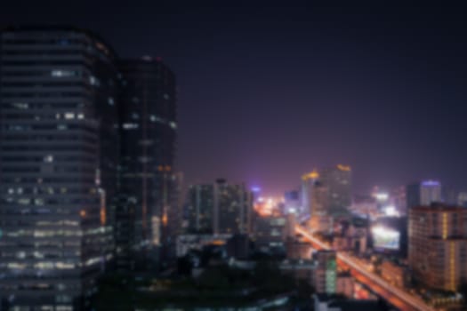 Abstract background of the night light trails on the modern building and traffic, shallow depth of focus