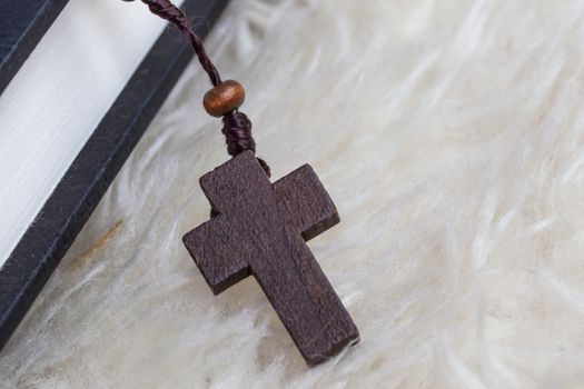 Christian cross necklace on Holy Bible book, Jesus religion concept as good friday or easter festival