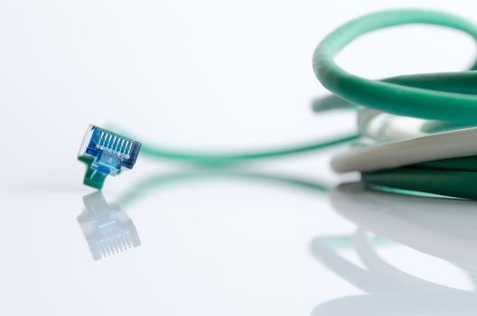 Green network cable on white