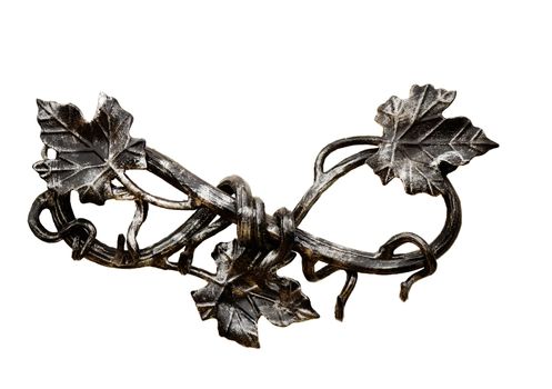 The branch of grapes with leaves, forged from metal. Presented on a white background.