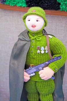 Funny figurine of a woman soldier, knitted knitting of yarn.