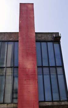 Modern building with glass facade in blue and red