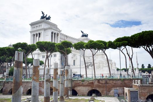 ROME, ITALY - SEPTEMBER 24, 2014: The Altare della Patria rising behind old ruins.