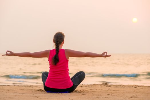 Woman in lotus position with arms outstretched to the sides