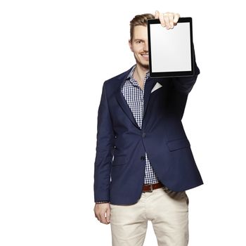 Portrait of a cheerful young businessman holding a blank digital tablet. Copy space.