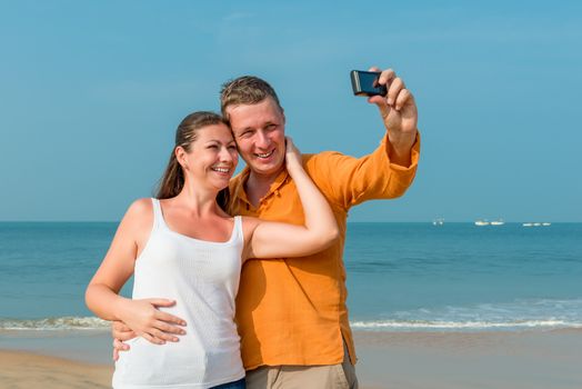 couple photographed in memory on the background of the sea