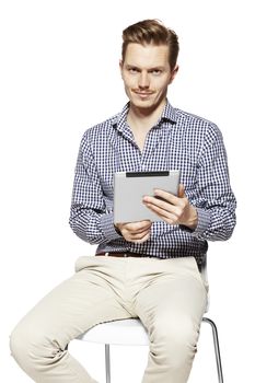 Young man is holding a tablet. Isolated on white background.