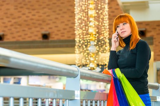 beautiful woman lost in thought at the mall