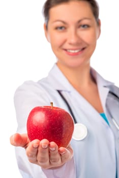 Smiling doctor holding a red apple in the palm