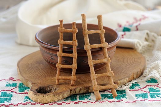Lestvitsi, Russian rye festive spring cookies, clay bowl and rushnik horizontal