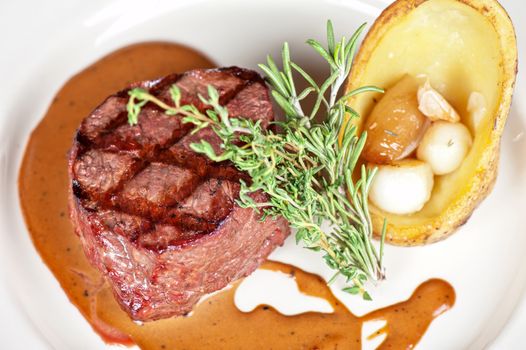 grilled beef steak with herbs and vegetables