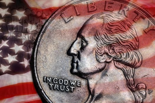 Close-up detail on a United States quarter dollar coin - In God we Trust - Liberty.