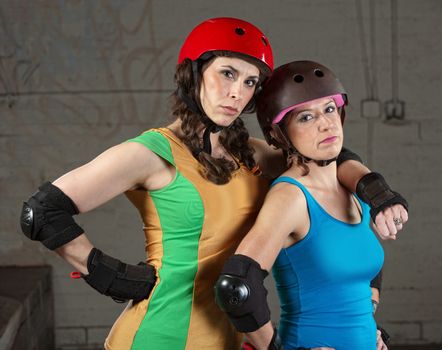 Confident female roller derby skating partners standing together