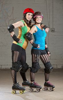 Pair of roller derby skater friends with helmets