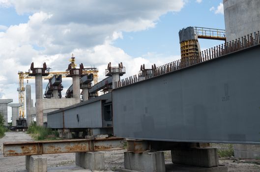 Bridge construction site with concrete piers already finished and still in the metal formwork.