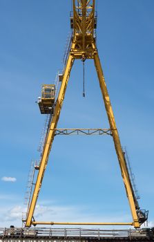 Gantry crane against the blue sky background