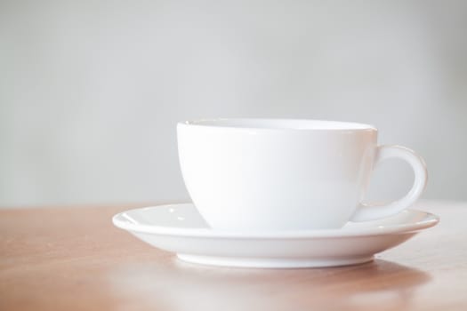 White coffee cup on wooden table, stock photo