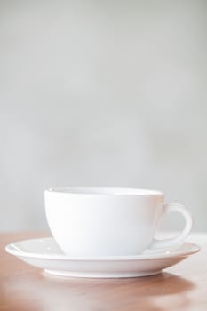 White coffee cup on wooden table, stock photo