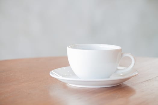 White coffee cup on wooden table, stock photo