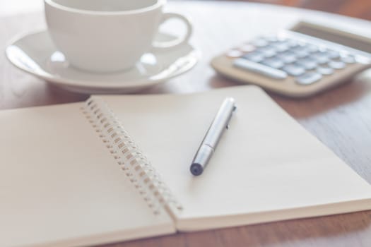 Blank notebook with pen on wooden table, stock photo