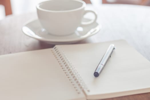 Blank notebook with pen on wooden table, stock photo